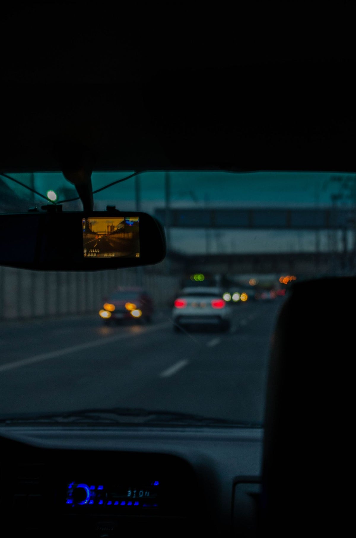 4K dual dash cam mounted on car windshield recording the road ahead